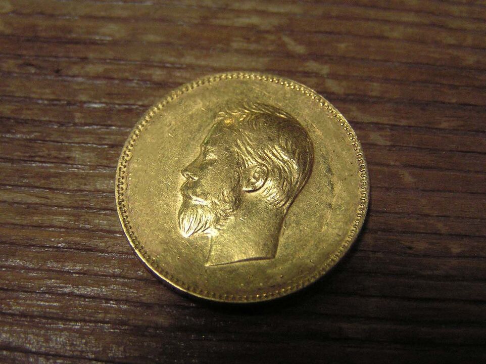 auksinė moneta finansinei gerovei